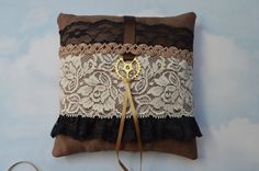 a decorative pillow with lace and a golden key hanging from the front on a wall