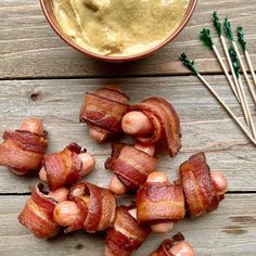 bacon wrapped in bacon with dipping sauce next to chopsticks on wooden table top