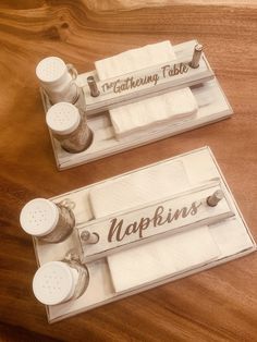 two trays with napkins and sewing needles on top of each one that says napkins