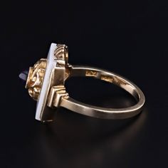 A unique ring featuring an amethyst cabochon atop a white agate backdrop. We created this unique 10k gold ring by riveting the top of an antique shirt stud (circa 1910) onto a 1920s era signet ring. The face of the ring measures 0.7 inches by 0.55 wide, and it is in good condition with some light crazing to the onyx (visible only under magnification). The ring is a size 6.25, but it can be resized free of charge. Materials: 10k gold, Agate, Amethyst. Art Deco Yellow Gold Enamel Ring For Formal Occasions, Art Deco Formal Yellow Gold Enamel Ring, Formal Yellow Gold Art Deco Enamel Ring, Formal Art Deco Yellow Gold Enamel Ring, Antique 14k Gold Hallmarked Opal Ring, Antique 14k Gold Hallmarked Enamel Ring, Antique 14k Yellow Gold Enamel Ring, Antique 14k Gold Signet Ring With Cabochon, Vintage Opal Ring In 14k Gold