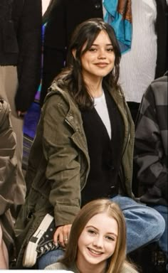 two women sitting next to each other at a basketball game