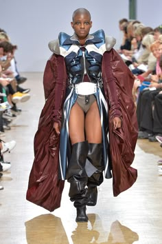 a model walks down the runway in a costume