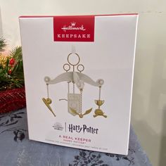 a harry potter christmas ornament is in the box on top of a table