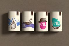 four lighters with different designs on them are lined up against a gray background,