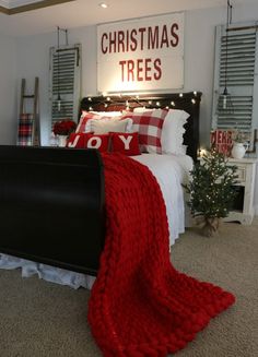 a bedroom decorated for christmas with red and white decor