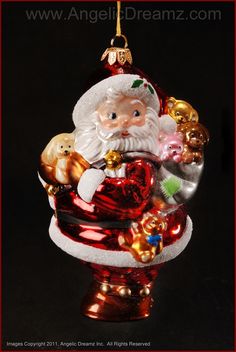 a glass ornament with santa claus holding a heart and other christmas decorations on it