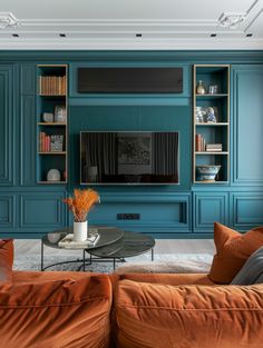 a living room filled with furniture and a flat screen tv mounted on a wall above a fireplace