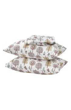 three pillows with trees printed on them