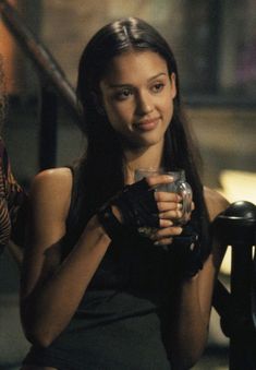 a woman holding a drink in her right hand