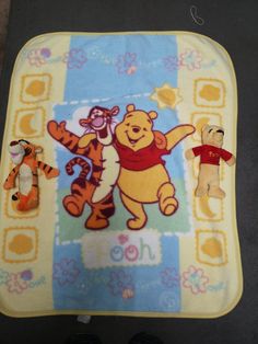 winnie the pooh and tigger baby blanket with two stuffed animals on it's side