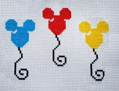 three cross stitch mickey mouse balloons on a white background with red, yellow and blue colors