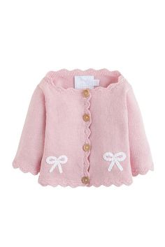 a pink sweater with sheep embroidered on the chest and buttons at the bottom, in front of a white background