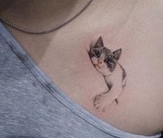 a woman with a cat tattoo on her chest