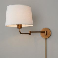 a wall light with a white shade on it