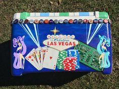 this is an image of a las vegas sign with playing cards and casino chips on it