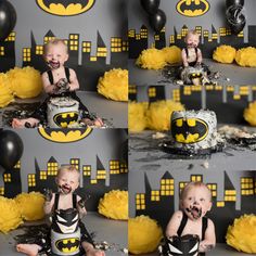 a baby is sitting in front of a batman cake