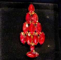 "SALE Vintage ATTRUIA Style Red Marquise Rhinestone Christmas Holiday Brooch Pin In Gold Tone Faceted Swarovski Crystal Vintage Collectible Pins Retro High End Quality Made Un-Signed ATTRUIA Red Marquise Rhinestone Christmas Tree Pin From the 60's. Picture #5 shows an Attruia Book Piece Pin. This pin is not a reproduction, it is a collectible retro brooch from the 60's. The brooch came to me in a velvet lines SWAROVSKI box, which will be included with the sale of the pin. This pin features eleve Red Formal Costume Jewelry Brooches, Red Rhinestone Brooches For Wedding, Red Rhinestone Wedding Brooches, Formal Red Rhinestone Brooch, Formal Red Rhinestones Brooches, Elegant Red Holiday Brooch, Elegant Red Holiday Brooches, Holiday Wedding Jewelry Brooch, Elegant Red Christmas Brooches