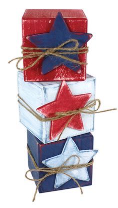 three wooden blocks with red, white and blue stars on them are tied to twine