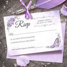 a purple wedding rsp card on top of a piece of paper next to a feather quill