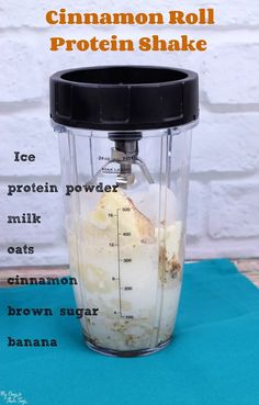 a blender with ingredients for cinnamon roll protein shake in it on a blue mat