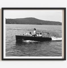 a black and white photo of people in a boat