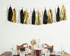 the table is set with black and gold decorations