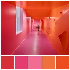 an orange and pink color scheme with a person walking down the hallway