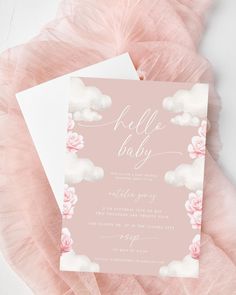 a pink and white baby shower with flowers on the bottom is next to a card that says hello baby