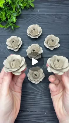 someone is holding paper flowers in front of the camera and making them look like they are made out of clay