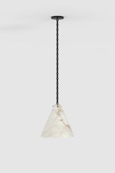 a black and white pendant light hanging from a chain on a gray wall with a marble triangle shaped object in the center