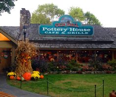 the front entrance to pottery house cafe and grille with pumpkins on display in front