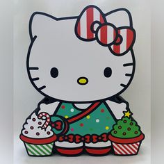 an image of a hello kitty holding cupcakes