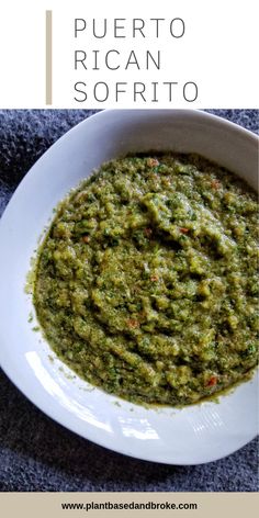 a white bowl filled with green sauce on top of a table