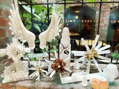 several decorative items displayed on a table in front of a window with iron bars behind them