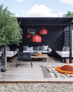 an outdoor living area with couches and tables