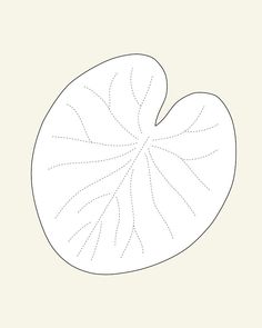 a white paper cut out to look like a leaf with dots on the edges and bottom