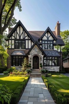 a large house with many windows and lots of greenery in the front yard area