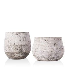 two white vases sitting next to each other