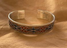 "This is a great silver and enamel cuff bracelet from Morocco. It measures just under 5/8\" (1,45 cm) at the widest and the inner diameter is just over 2 3/8\" (6,1 mm) wide. It is slightly adjustable as it is a cuff style bracelet. The bracelet features fantastic filigree-style wirework with unique-colored enamel." Moroccan Bracelet, Protection Amulet, African Jewelry, Big Earrings, Wire Work, Unique Colors, Fashion Bracelets, Cuff Bracelet, Pendant Jewelry