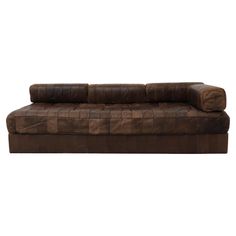 a brown leather couch on a white background