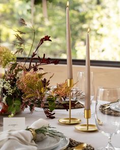 the table is set with candles and place settings