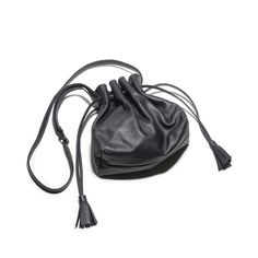 Indulge in luxury with the Lala Black Drawstring Bag. Crafted from smooth leather and lined with fabric, this bag boasts a tassel detail and round knotted straps. Practical and versatile, it seamlessly blends elegance and timelessness for the ultimate accessory. Elevate your style today. Chic Daily Use Bucket Bag With Tassels, Leather Bucket Bag With Tassels For Travel, Crossbody Bucket Bag With Tassels For Travel, Travel Crossbody Bucket Bag With Tassels, Travel Bucket Bag With Tassels And Crossbody Shape, Daily Use Crossbody Bucket Bag With Tassels, Daily Crossbody Bucket Bag With Tassels, Story London, Elevate Your Style