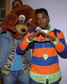 a man standing next to a large stuffed animal