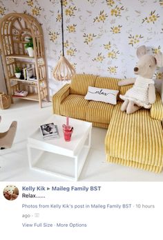 a yellow couch sitting next to a white table