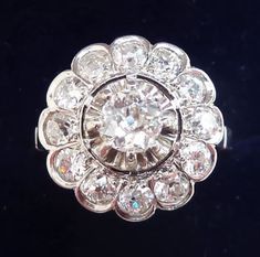 Date made: 1930's Diamond content: 0.84ct Metal: platinum Finger length 14mm Condition: Excellent commensurate to it's age Ring Size: UK/AUS I1/2   US/CAN 41/2  can be resized This beautiful antique ring originates from the 1930's. The ring showcases a gorgeous 5mm/0.45ct old cut diamond. Accompanying the central diamond are a further 12 matching 2mm/0.03ct old cut. These SI clarity H colour dazzling diamonds that offer a fabulous flash and total 0.84ct. The shank is solid platinum with french h Antique Jewellery Online, Antique Rings Vintage, Antique Ring, Gorgeous Art, Engagement Anniversary, Antique Jewellery, Antique Rings, Cluster Ring, Anniversary Rings