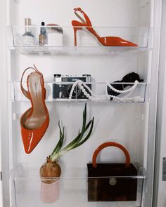 there is a shelf with shoes and purses on it