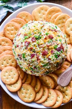 a cheese ball on a plate with crackers