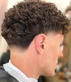 Cool Curly Blowout Fade. These stylish blowout haircuts for men offer undeniable charm, versatility and timeless flair for a masculine, casually cool vibe. Best Fades For Curly Hair Men, Curls With Taper Fade, Tapper Fade Men Curly Long Hair, Curly Top Taper Fade, High Tapper Hair Men, Low Mid Fade Curly Hair, Mid Taper Wavy Hair, Fohawk Haircut Fade Curly, Short Curly Taper Fade