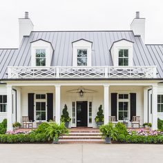 a white house with black shutters and windows