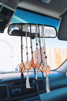 a car dashboard with some beads hanging from it